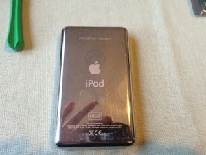 The slightly battered back of my iPod showing my name engraved. A service you could get when ordering directly from Apple free of charge.