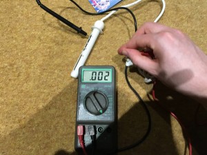Using a meter to measure the continuity between the device and the pins.