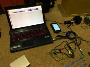 My setup with my laptop, cables, crocodile clips, resistor, and phone.